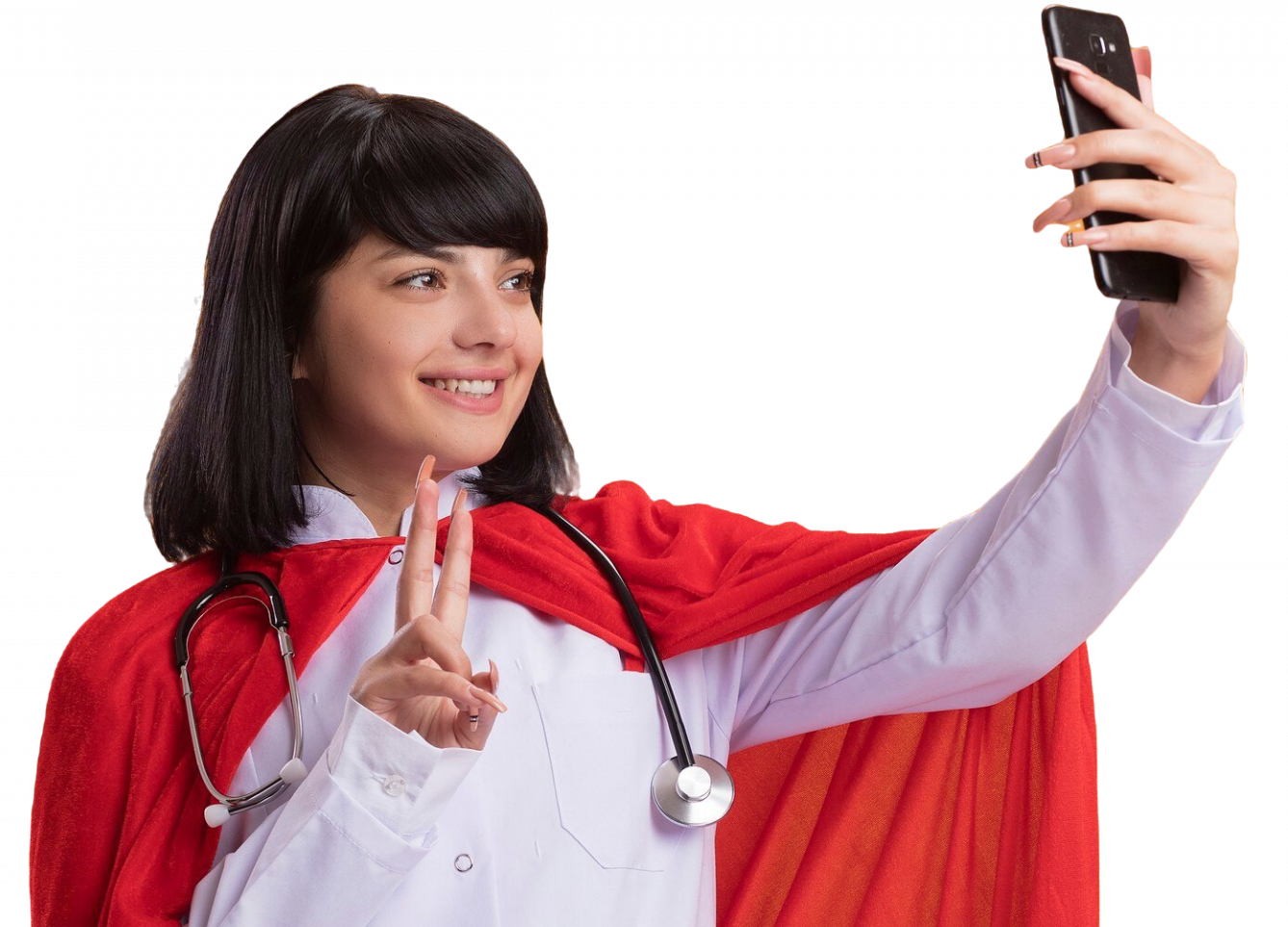 Smiling young superhero girl wearing stethoscope with medical robe and cloak checking in the clinic via facereader staff attendance system integrated in healthcare application showing peace gesture