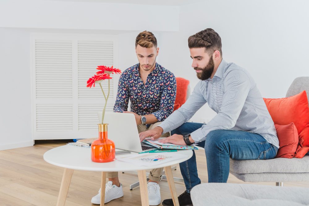 Men working with laptop in office exploring seo for therapists