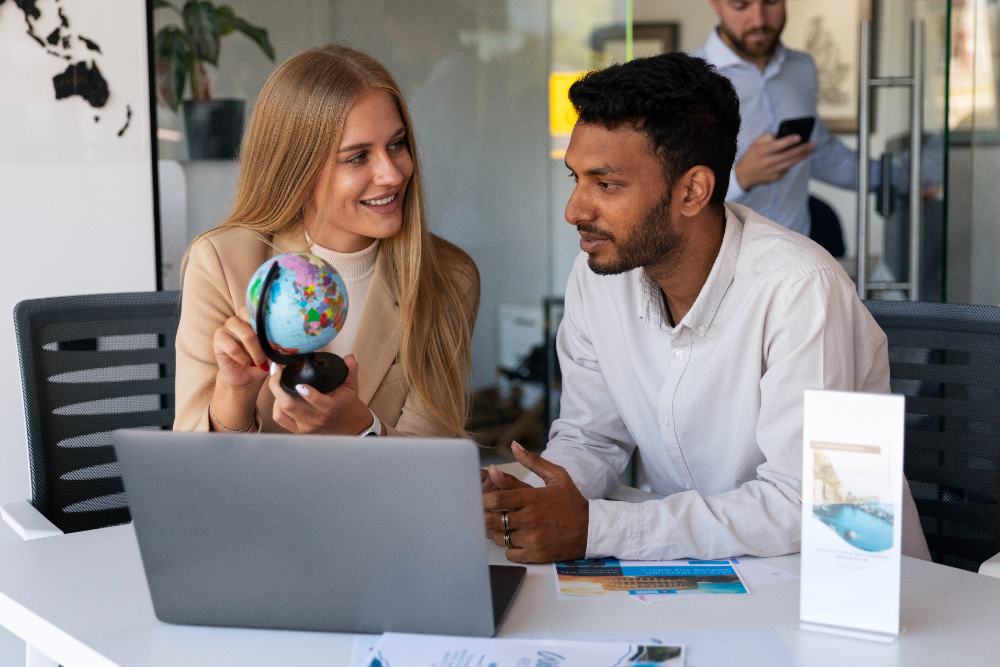 male seo consultant explaining about globe map to a female that how she can find best services near her while in united states