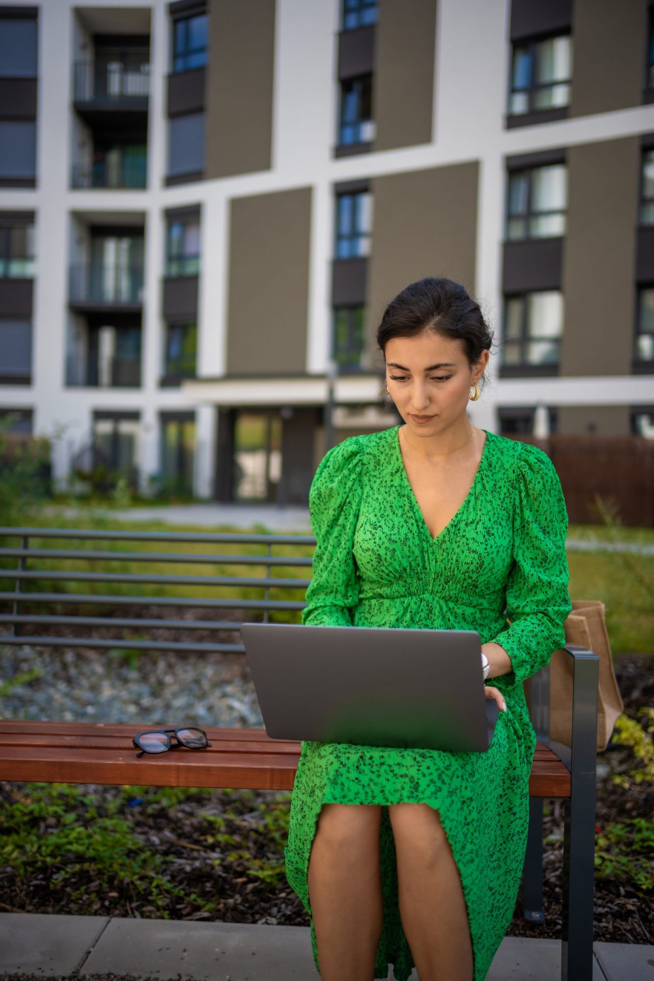 caucasian-woman-working-with-laptop-computer-outside-office