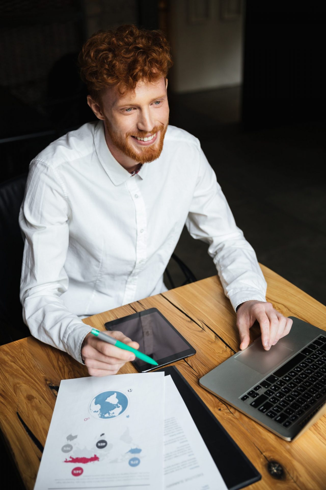 close-up-portrait-young-cheerful-redhead-curly-business-man-white-shirt-working on affordable seo services enhancement looking-aside