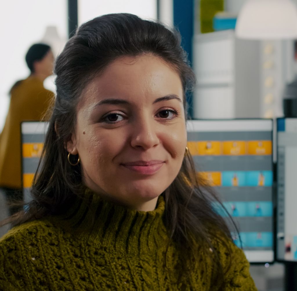 web application development female staff profile picture at her office desk