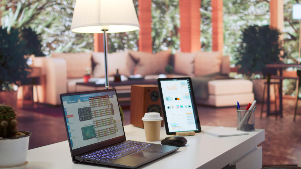 Empty home setup desk filled with documents and financial reports while laptop screen displaying hotel website design