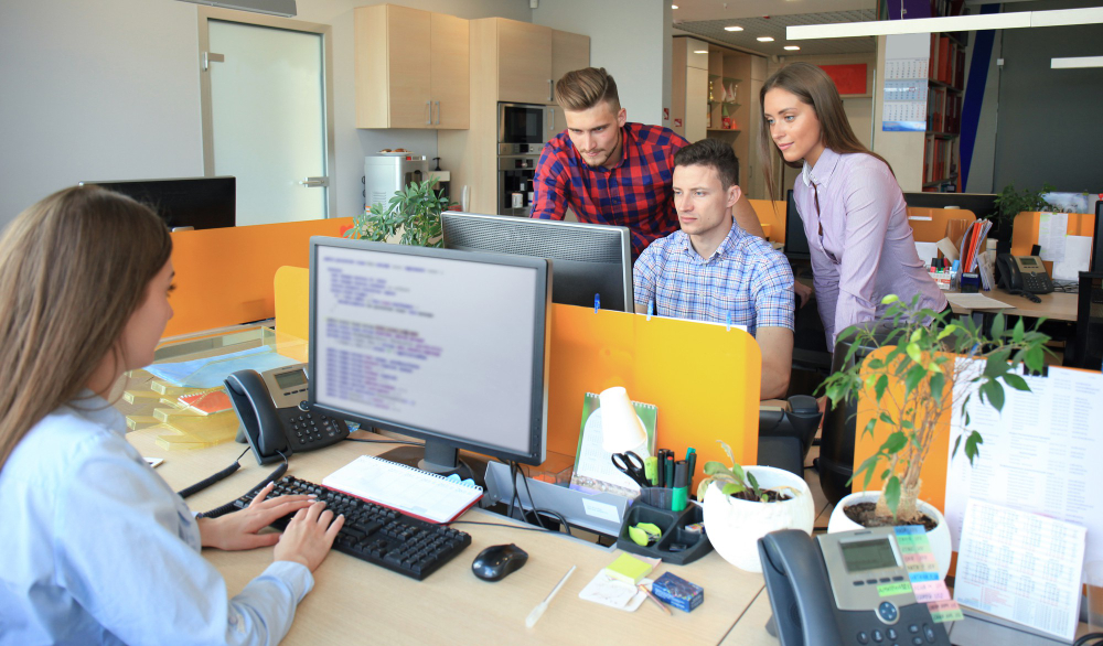 Group of young business professionals having a meeting. Diverse group of young website developer smiling during a meeting at the office.